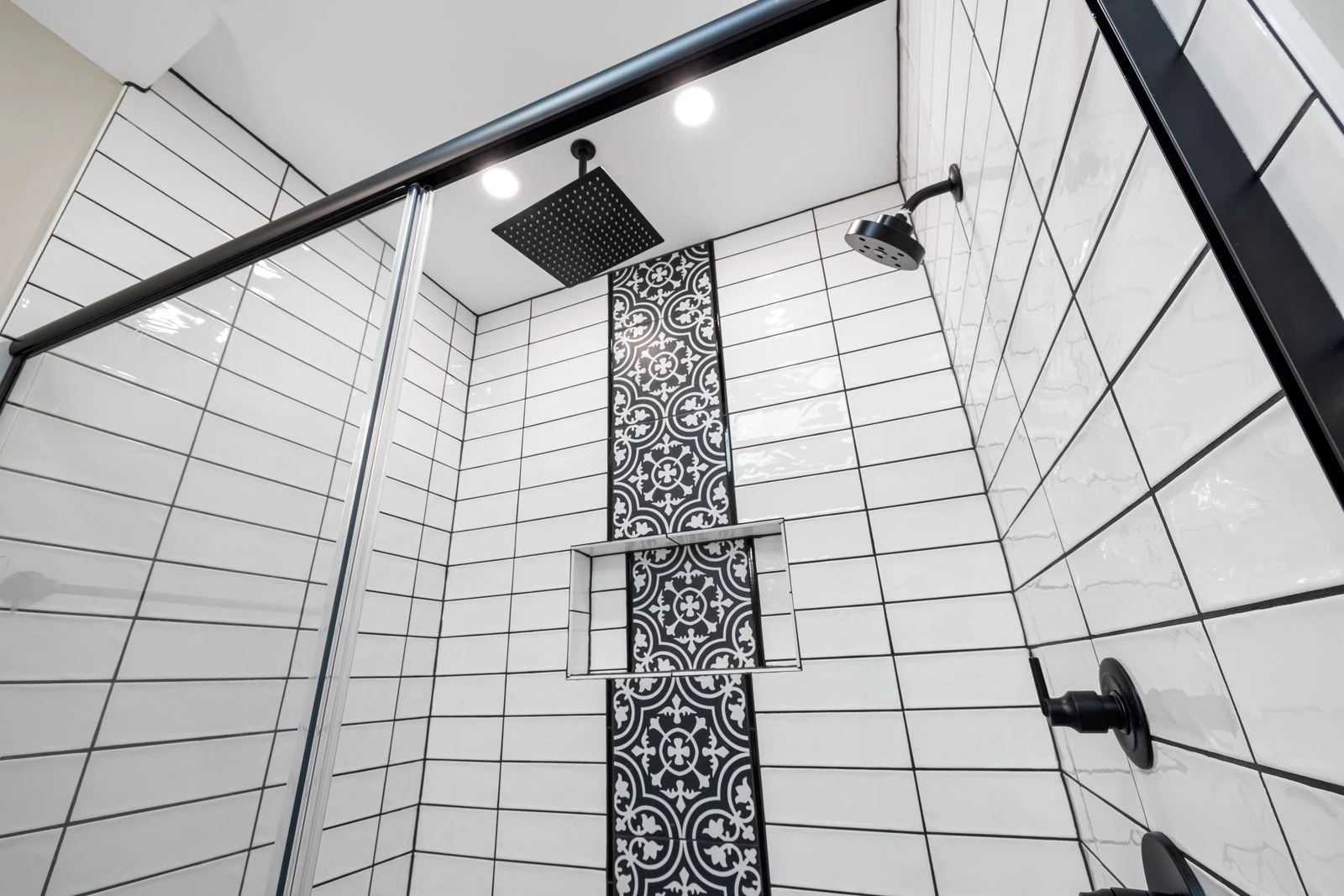 Black shower head and patterned tiles