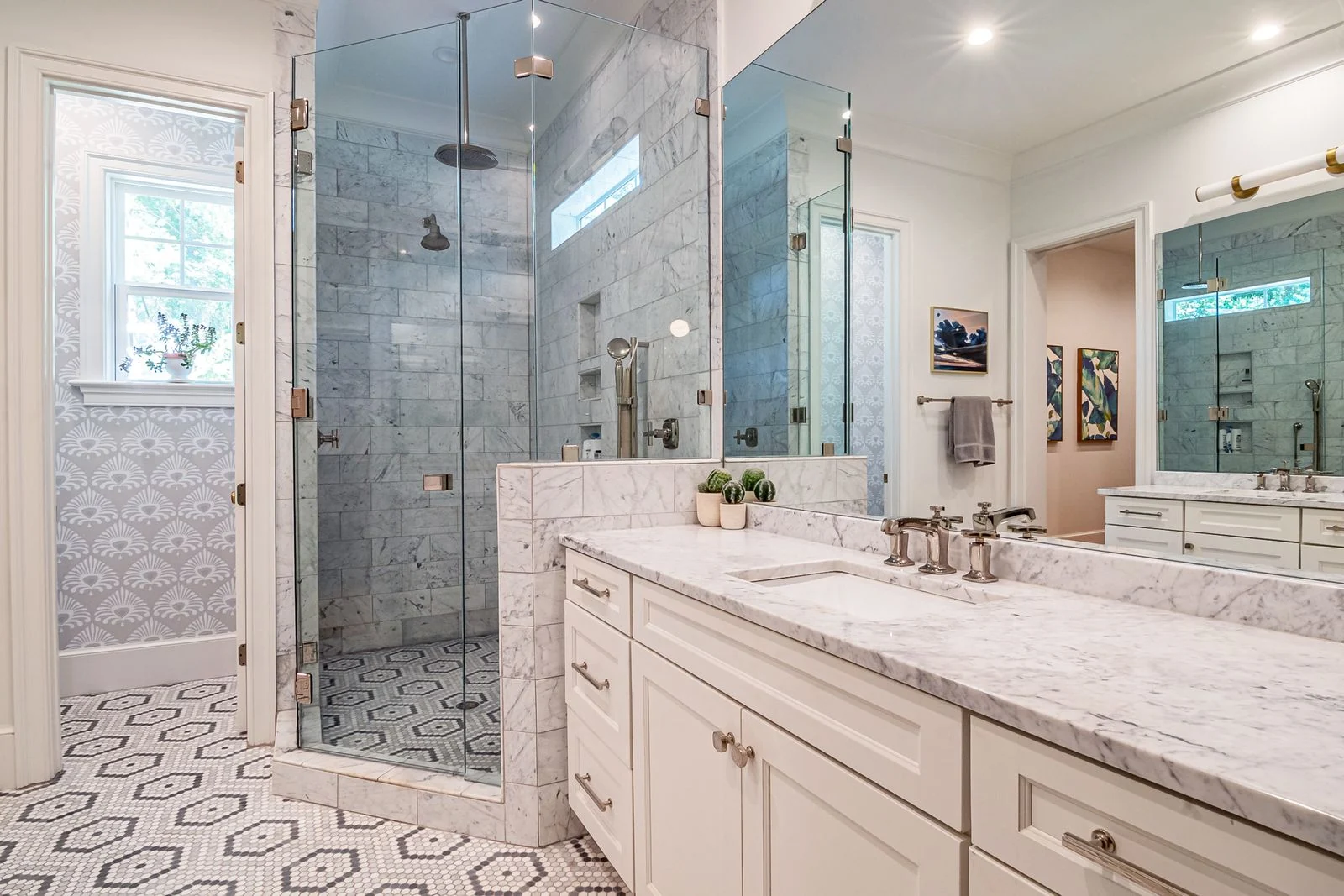 Elegant bathroom with marble countertops, glass shower, and stylish Mediterranean decor